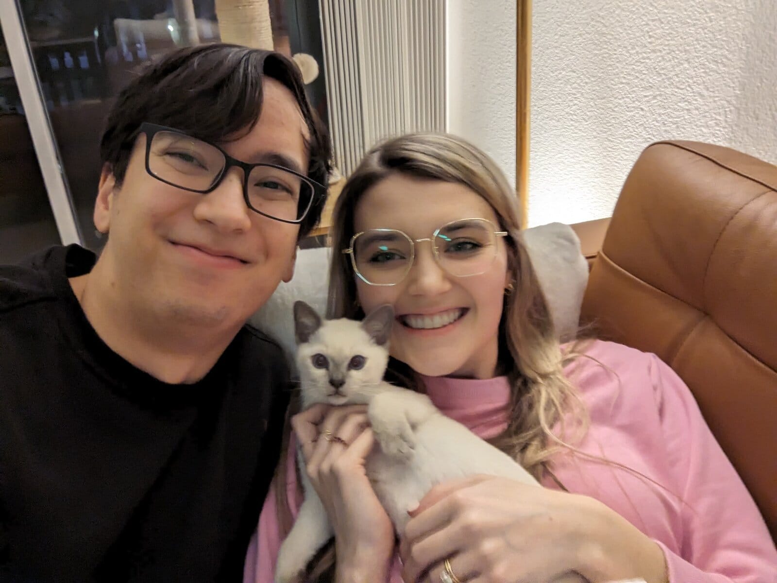 Couple holding white kitten