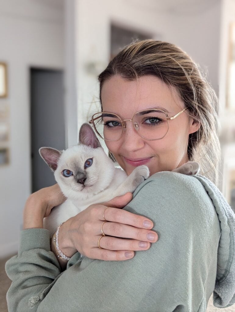Woman holding white kitten