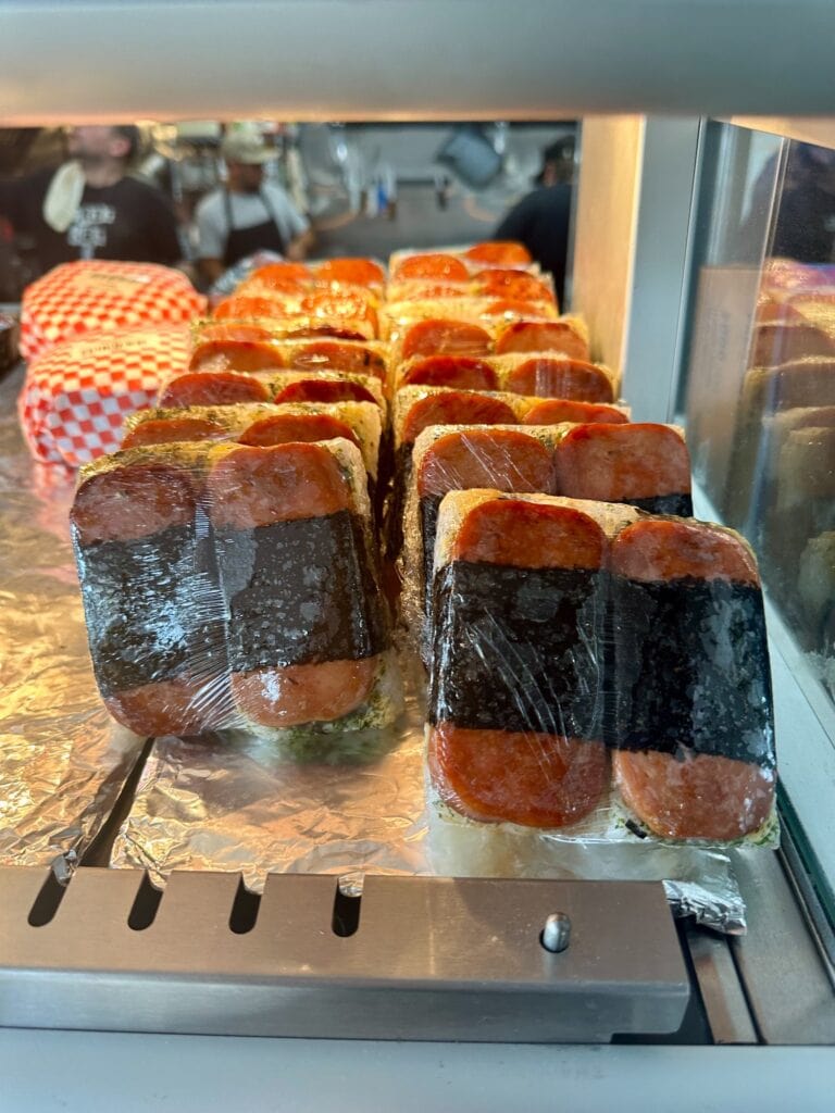 Close-up of spam musubi lined up in a display case at Gnar Bar