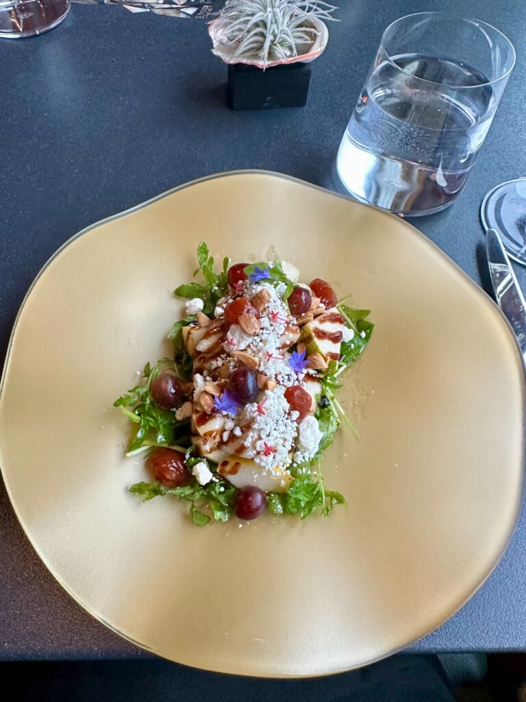 Pear and goat cheese salad with candied nuts and greens at Greenwood Restaurant