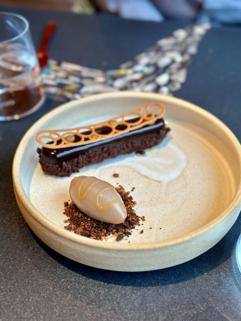 Elegant chocolate dessert with ice cream and caramelized garnish at Greenwood Restaurant