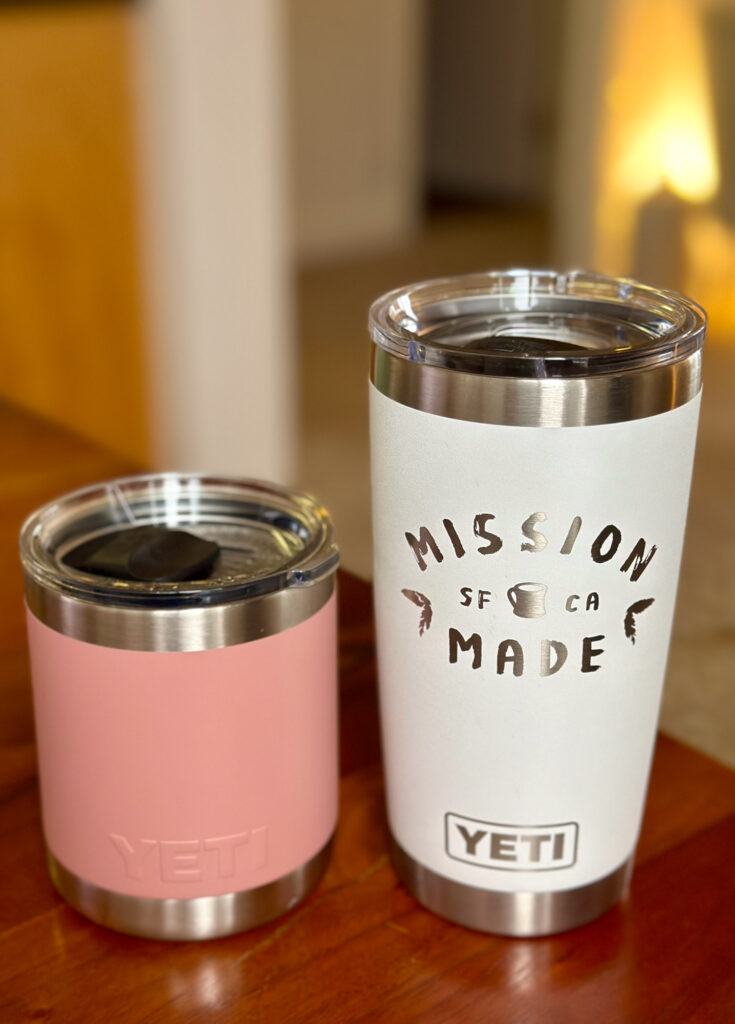 Two Yeti travel mugs in pink and white — practical and stylish drinkware for busy Enneagram 3s or minimalists.