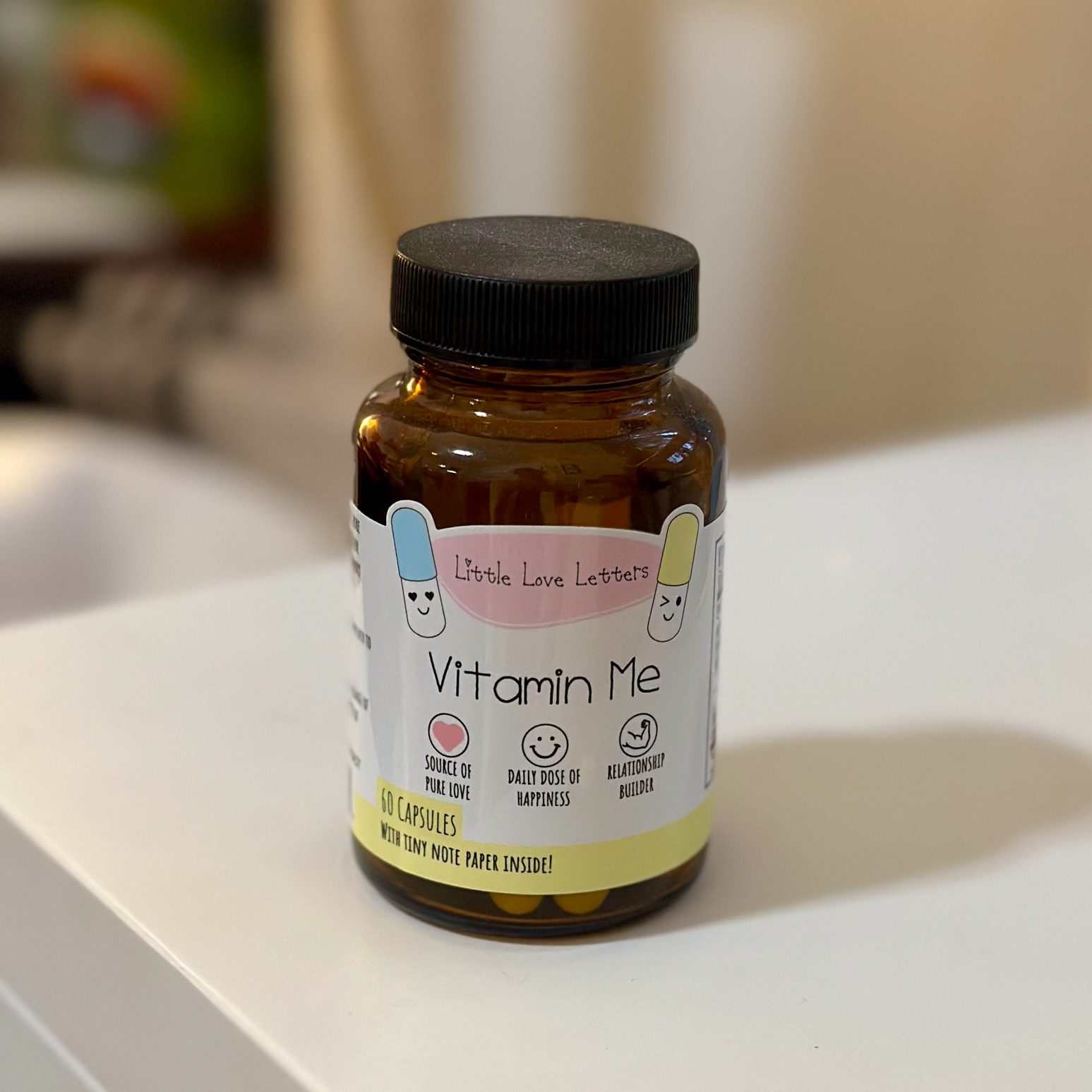 Amber glass bottle labeled “Vitamin Me” filled with mini love notes — a meaningful relationship gift for Enneagram 3s.