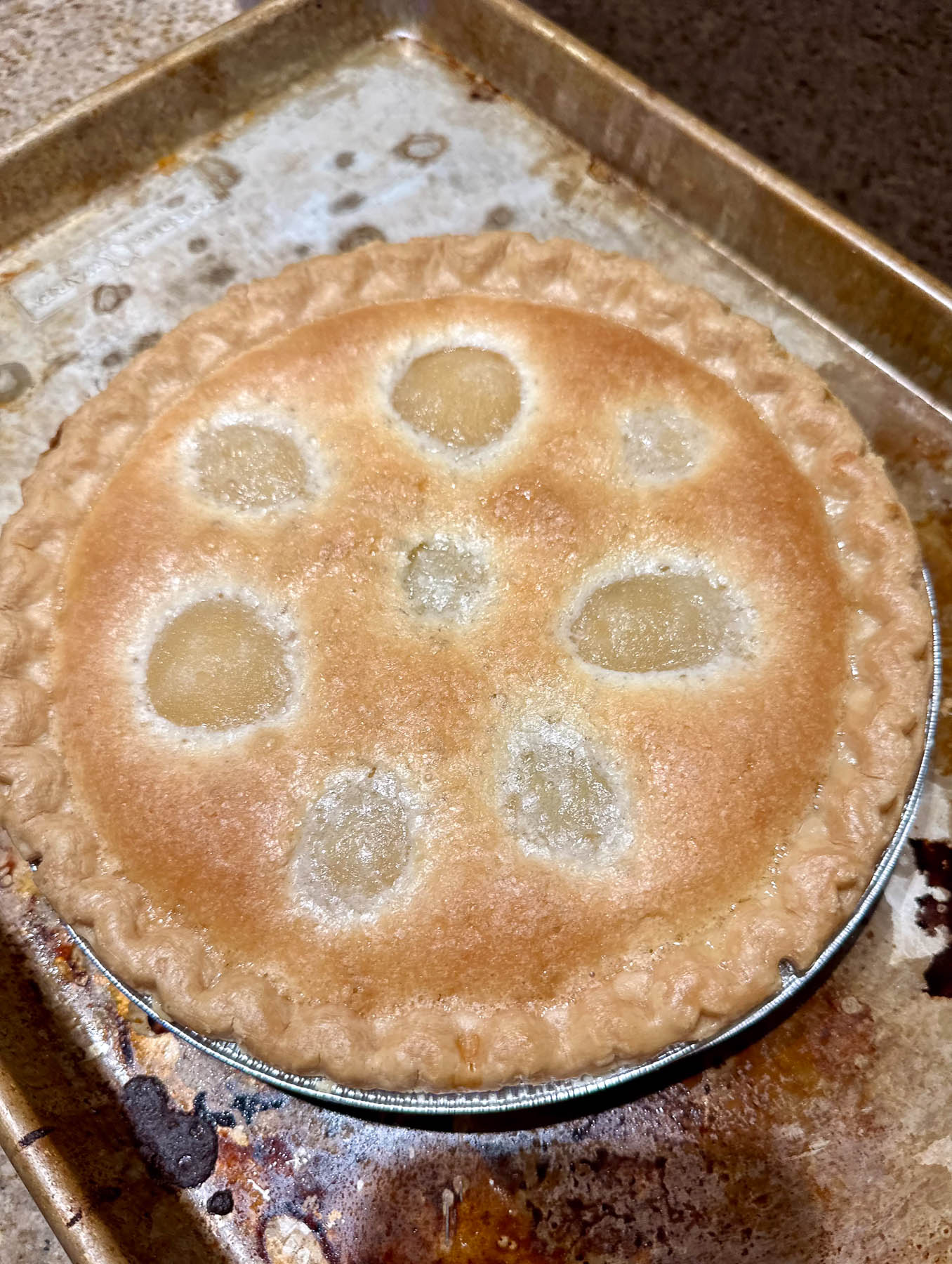 Finished pear pie with a golden crust and pear shapes visible through the topping.