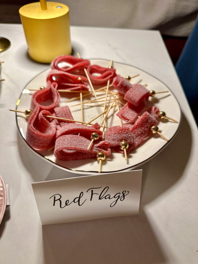 Red sour candy strips on skewers labeled “Red Flags,” a Love Is Blind inspired treat.