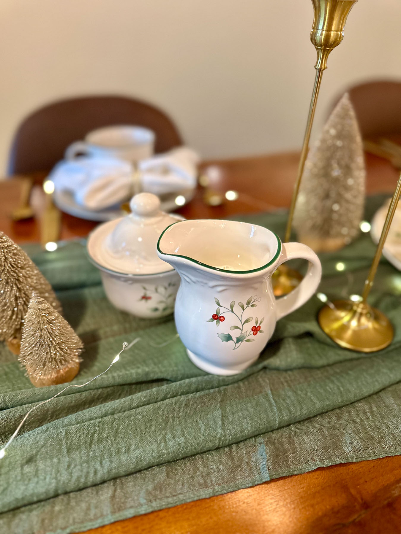 Holiday creamer and sugar bowl with holly pattern on a Christmas tea party table