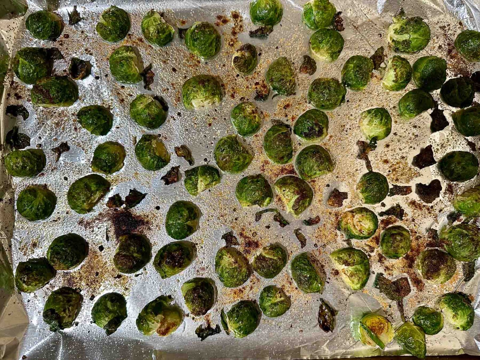 Roasted Brussels sprouts on a sheet pan with crispy, browned edges.