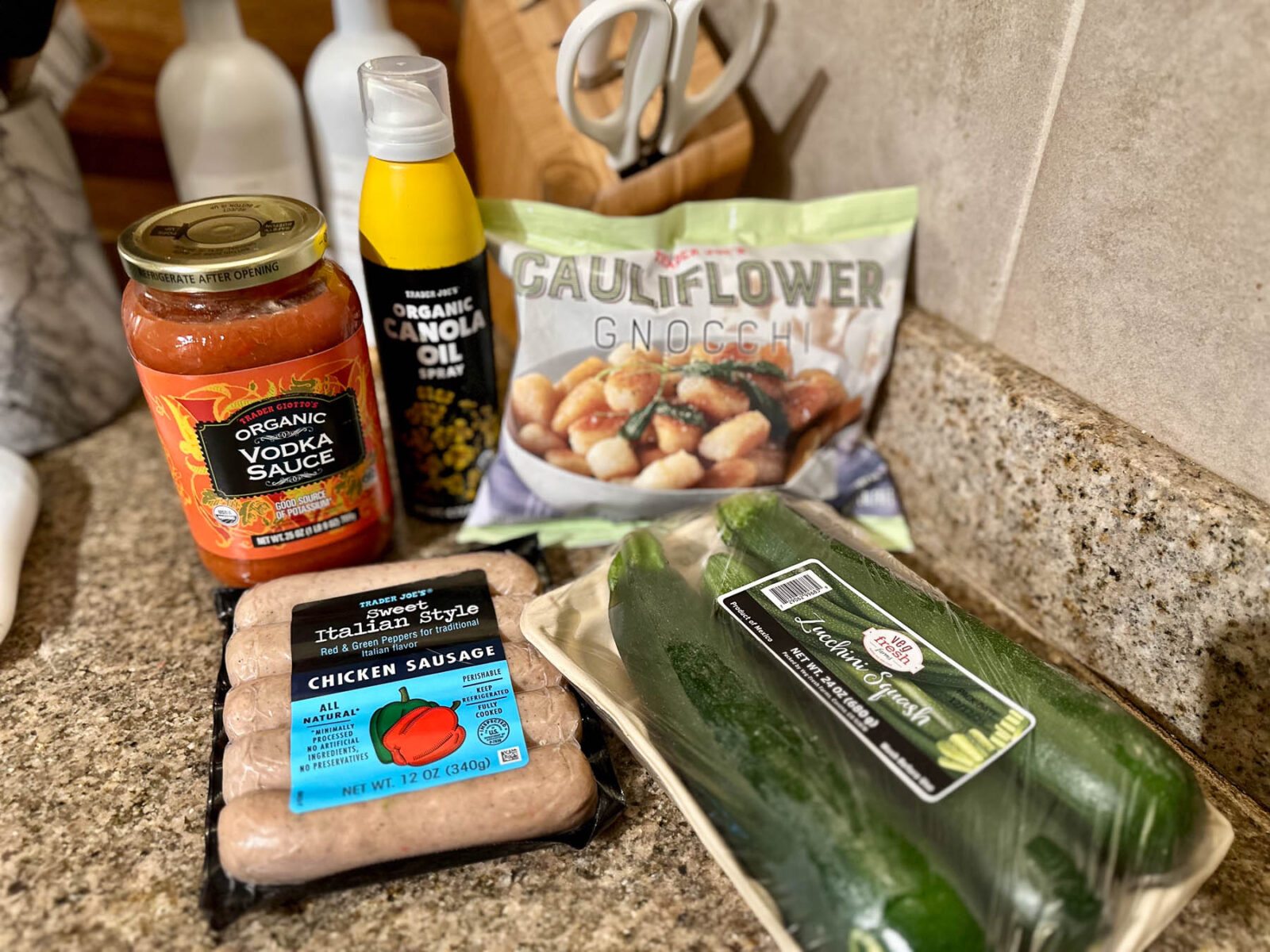 Trader Joe’s ingredients for a cauliflower gnocchi bowl, including cauliflower gnocchi, sweet Italian chicken sausage, zucchini, vodka sauce, and canola oil spray.