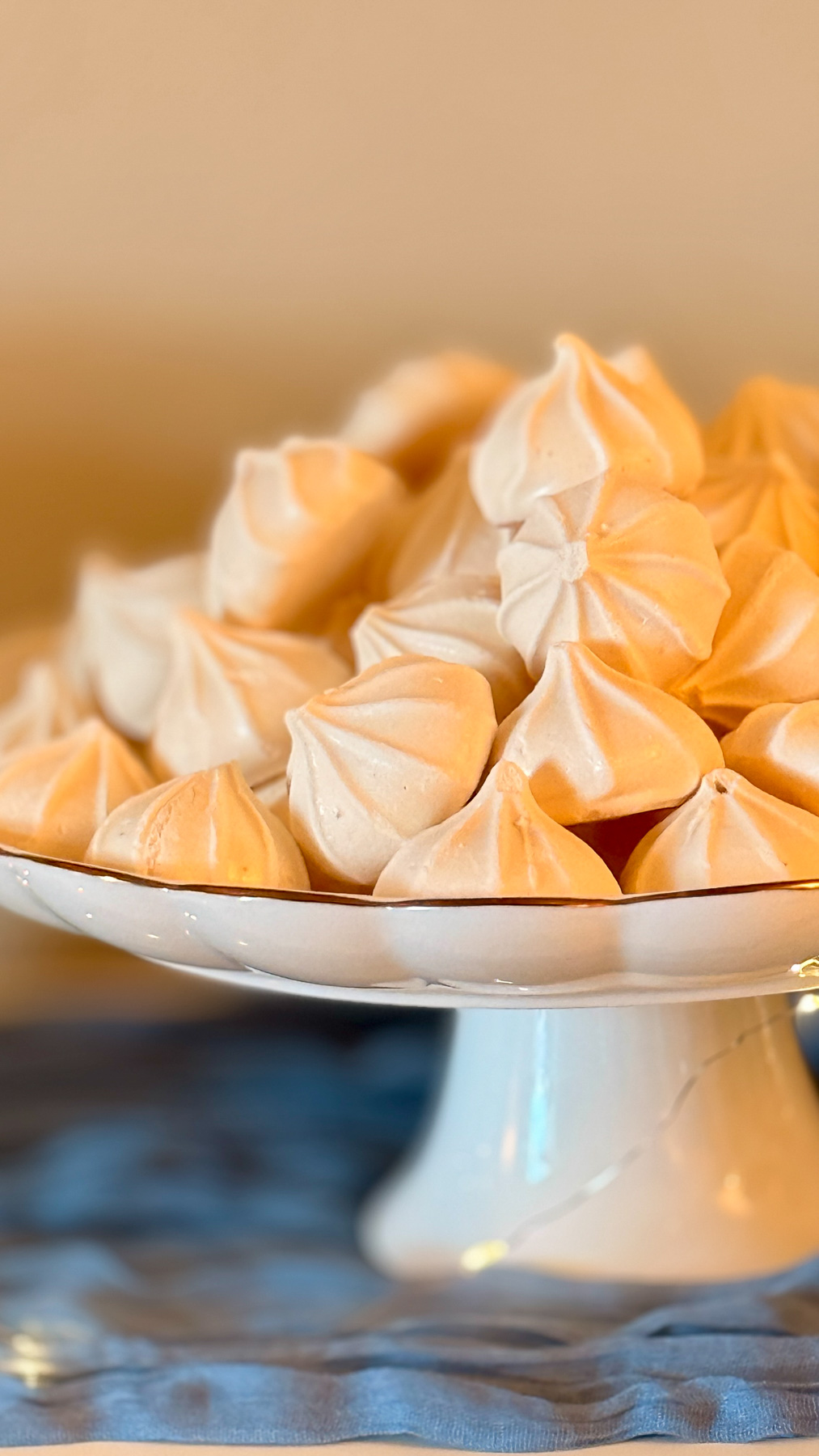 Meringue cookies styled as “clouds” for a baby shower dessert table