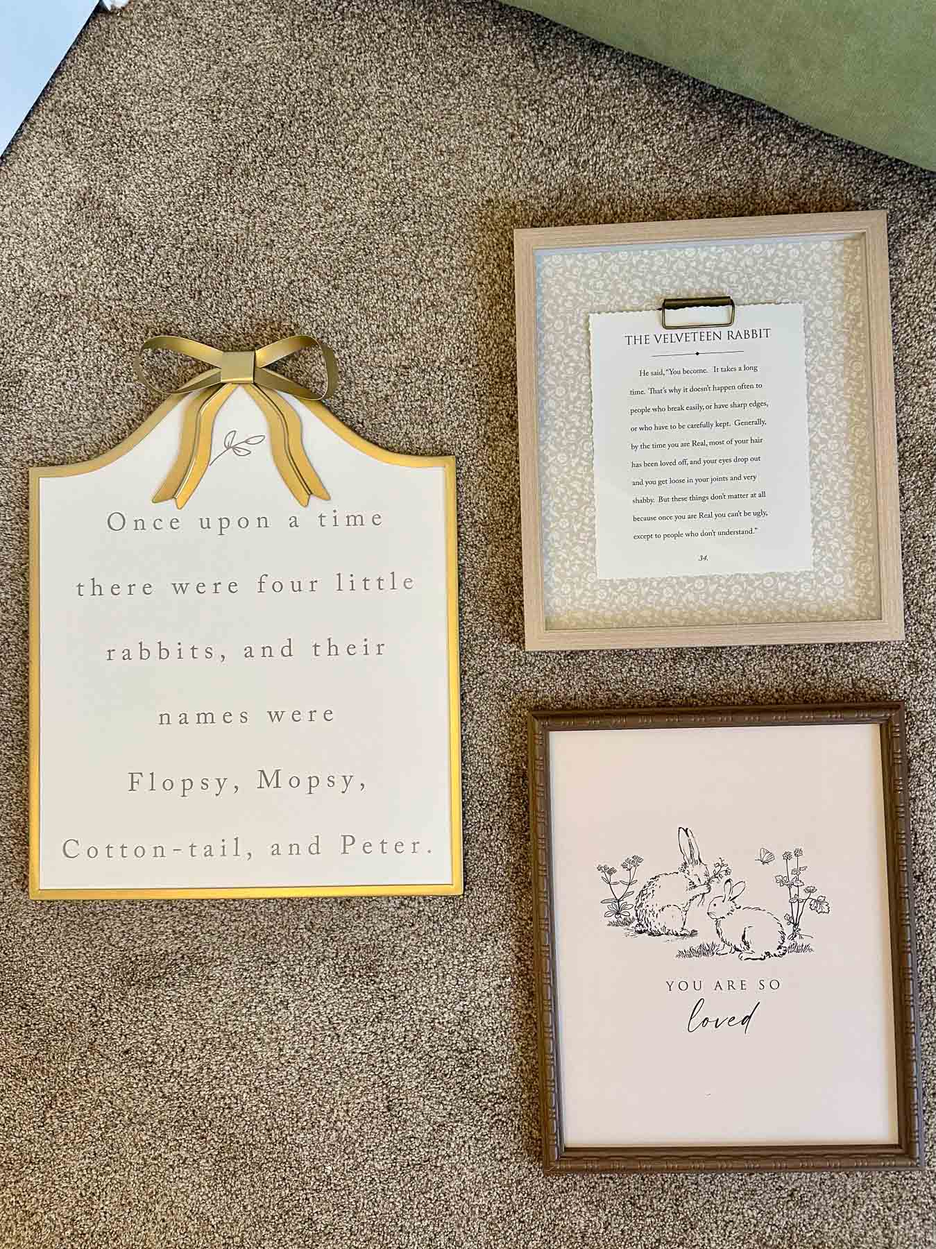 Framed nursery wall decor prints including a bunny illustration and Beatrix Potter quote.