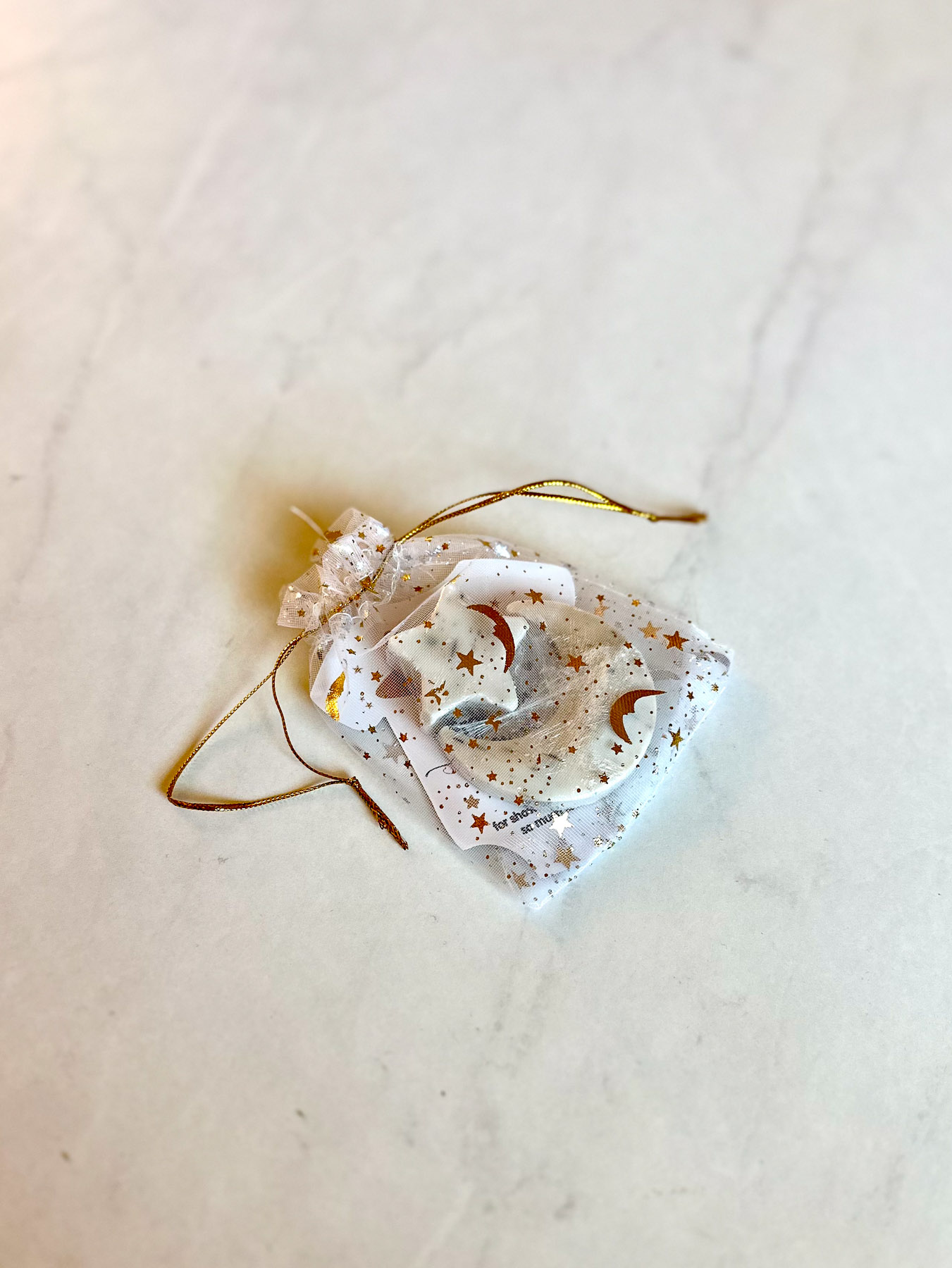 Lychee soap favor wrapped in sheer bag with gold star details