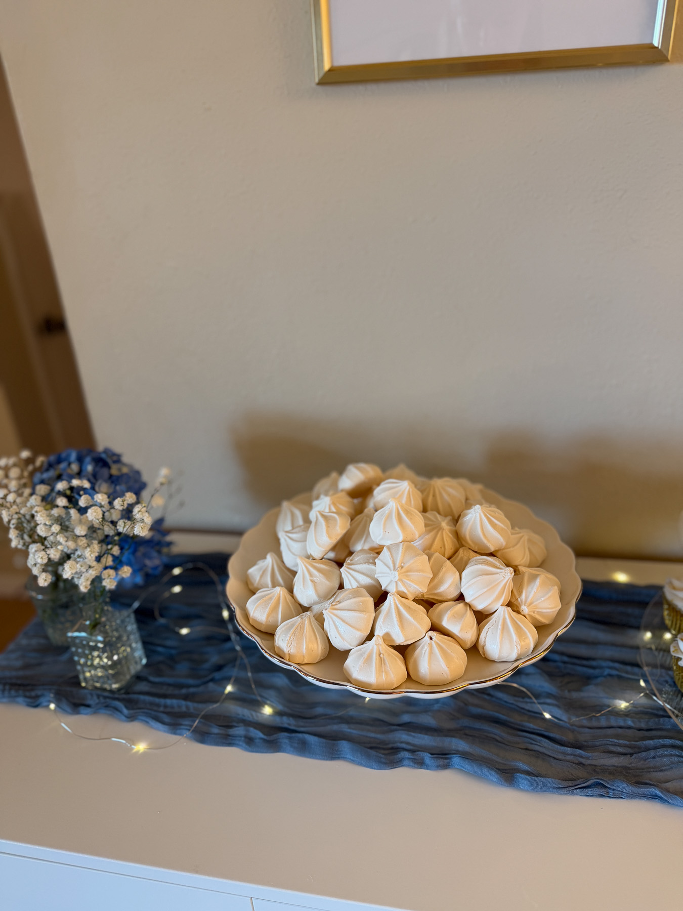 Meringue cookies styled as “clouds” for an Over the Moon baby shower dessert table